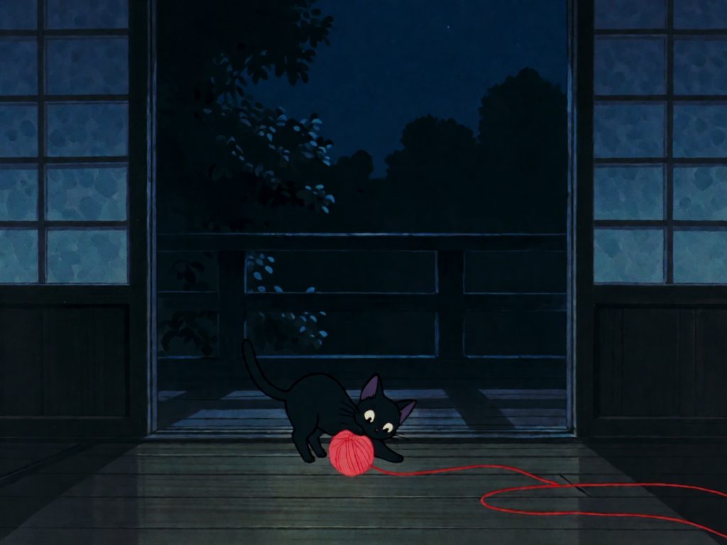 Painting of a black cat playing with a ball of red yarn at night
